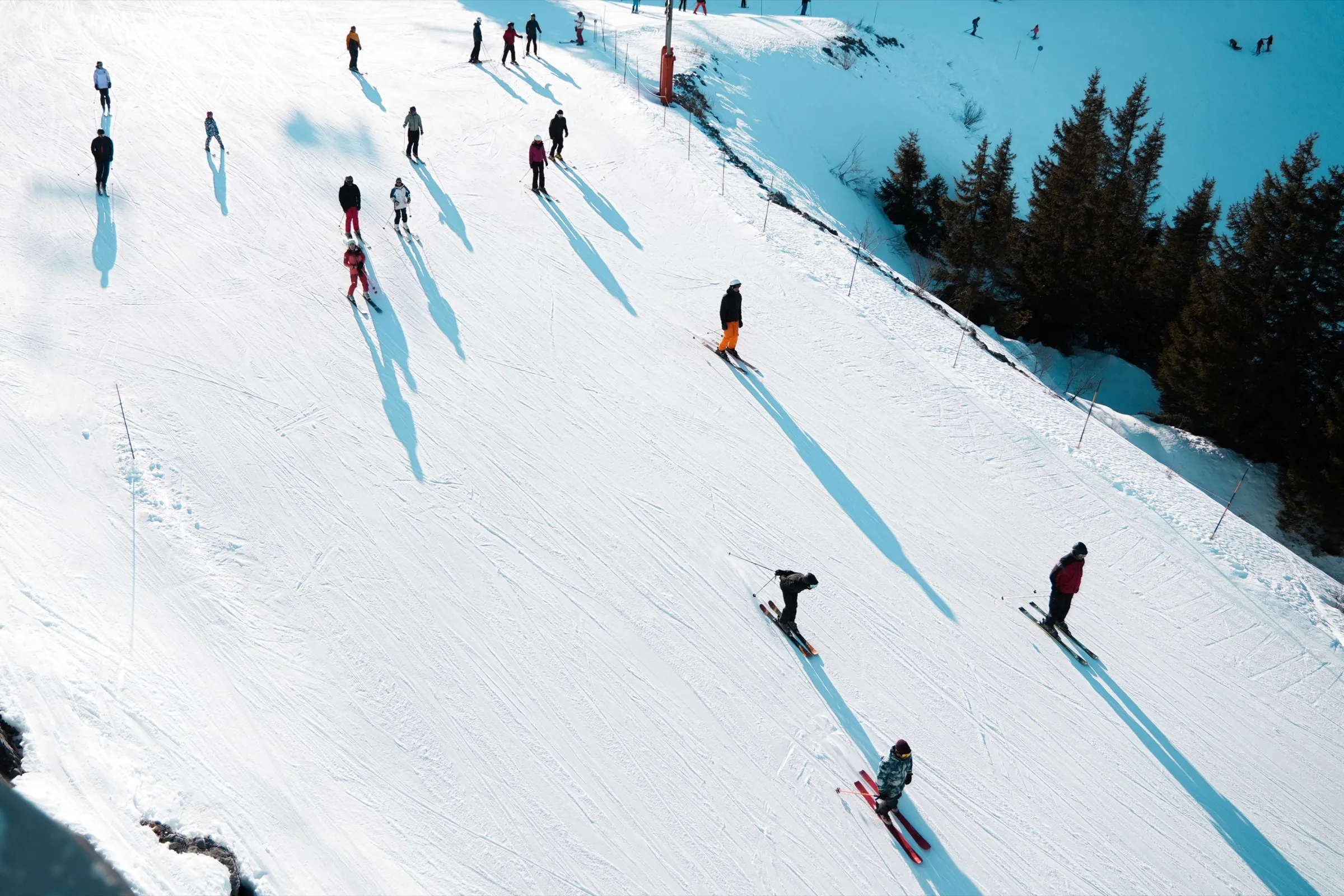 A Peak instructor leading a lesson on a sunlit Alpine piste.